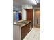 Galley kitchen featuring stainless steel dishwasher and granite countertops at 11574 Westwood Blvd # 1126, Orlando, FL 32821