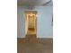 Neutral living room with light-colored carpet, white walls, and a hallway leading to other rooms at 11574 Westwood Blvd # 1126, Orlando, FL 32821