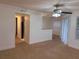 An open-concept living room features neutral walls, carpet, and a ceiling fan with access to the kitchen at 11574 Westwood Blvd # 1126, Orlando, FL 32821