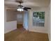 Bright living room with fan, breakfast bar, and sliding glass doors to the outside at 11574 Westwood Blvd # 1126, Orlando, FL 32821