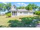 Secluded backyard featuring a well-maintained lawn and an enclosed porch area on a bright day at 1210 S Clayton St, Mount Dora, FL 32757