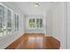 Sunlit room with wood floors, several large windows, and neutral-colored walls at 1210 S Clayton St, Mount Dora, FL 32757