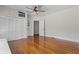 Bedroom with wood floors, a ceiling fan, closet, and entry to another room at 1210 S Clayton St, Mount Dora, FL 32757