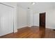Cozy bedroom featuring wood floors, closet, and a unique barn-door entry at 1210 S Clayton St, Mount Dora, FL 32757