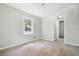 Bright bedroom with two windows and a doorway leading to the bathroom provides cozy space at 1210 S Clayton St, Mount Dora, FL 32757