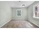 Cozy bedroom features neutral carpet, natural light from the windows, and freshly painted walls at 1210 S Clayton St, Mount Dora, FL 32757