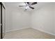 This bedroom has neutral walls, a ceiling fan, one window, and tile floors at 1210 S Clayton St, Mount Dora, FL 32757