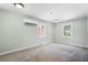Bedroom with neutral carpet and two windows at 1210 S Clayton St, Mount Dora, FL 32757