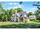 Picturesque cottage with arched windows, screened porch, and large yard at 1210 S Clayton St, Mount Dora, FL 32757