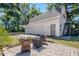 Detached garage and a brick patio offer a scenic place for entertaining or relaxation at 1210 S Clayton St, Mount Dora, FL 32757