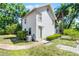 Charming white two-story house with lush landscaping at 1210 S Clayton St, Mount Dora, FL 32757