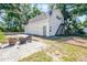 Detached garage and a brick patio offer a scenic place for entertaining or relaxation at 1210 S Clayton St, Mount Dora, FL 32757