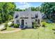 Charming two-story home with lush front yard, brick pathway, and traditional architectural details at 1210 S Clayton St, Mount Dora, FL 32757