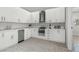 Modern kitchen featuring stainless steel appliances, white cabinets, and marble countertops at 1210 S Clayton St, Mount Dora, FL 32757