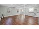 Spacious living room featuring laminate floors and kitchen at 1210 S Clayton St, Mount Dora, FL 32757