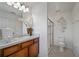 Well-lit bathroom featuring a vanity with a white sink, glass shower, and toilet with modern wall decor at 1230 Sand Torch Cir, Davenport, FL 33837