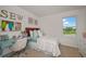 Charming bedroom with a daybed, a window overlooking the landscape, and a sewing station on the far wall at 1230 Sand Torch Cir, Davenport, FL 33837