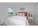 Inviting bedroom with a bed, matching bedside tables with lamps, a window, and modern wall decor at 1230 Sand Torch Cir, Davenport, FL 33837
