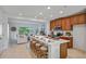 Open kitchen with island seating, stainless appliances, and open floor plan to living room at 1230 Sand Torch Cir, Davenport, FL 33837