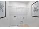 Empty laundry room featuring tile flooring, white walls, utility connections, and framed inspirational artwork at 1230 Sand Torch Cir, Davenport, FL 33837