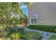 Lush backyard featuring manicured hedges, plants, and a well-maintained lawn at 1251 Arlington Pl, Winter Park, FL 32789