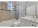 Bathroom with a tiled shower and bathtub combination, white sink vanity, and modern fixtures at 1251 Arlington Pl, Winter Park, FL 32789
