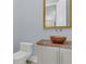 Bathroom featuring a decorative bowl sink on a marble countertop, with a toilet alongside at 1251 Arlington Pl, Winter Park, FL 32789