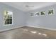 Spacious bedroom with neutral walls, tile floors, a ceiling fan, and plenty of natural light from large windows at 1251 Arlington Pl, Winter Park, FL 32789