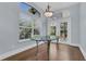 Dining room with hardwood floors, a modern chandelier, and large windows that offer lots of natural light at 1251 Arlington Pl, Winter Park, FL 32789