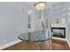 Bright dining room boasts a glass table and hardwood floors with fireplace and high ceilings at 1251 Arlington Pl, Winter Park, FL 32789