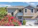 Charming two-story home featuring a two-car garage and an inviting front entrance with lush landscaping at 1251 Arlington Pl, Winter Park, FL 32789
