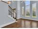 Bright living room featuring hardwood floors, a staircase, and ample natural light from large windows at 1251 Arlington Pl, Winter Park, FL 32789
