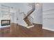 Open-concept living room showcasing hardwood floors, a modern fireplace, and a staircase with iron railings at 1251 Arlington Pl, Winter Park, FL 32789