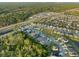Extensive aerial view shows a residential community surrounded by lush greenery and a highway nearby at 1328 Pompay Dr, Davenport, FL 33896