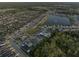 Aerial view of a home surrounded by single Gathering homes, a lake and community pool nearby at 1328 Pompay Dr, Davenport, FL 33896
