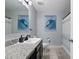 Bathroom featuring granite countertops, dark cabinets, and a large mirror with modern lighting at 1328 Pompay Dr, Davenport, FL 33896