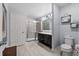This updated bathroom features a glass shower and double vanity at 1328 Pompay Dr, Davenport, FL 33896