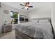 A well-lit bedroom with a ceiling fan and a large window at 1328 Pompay Dr, Davenport, FL 33896
