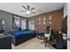 Bedroom with a ceiling fan, dark walls, a computer desk, and a bed with storage drawers at 1328 Pompay Dr, Davenport, FL 33896