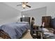 Comfortable bedroom featuring a dark wood headboard, dresser, computer desk, and neutral colored carpet at 1328 Pompay Dr, Davenport, FL 33896