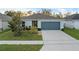 Charming single-story home with a well-maintained lawn and attached two-car garage at 1328 Pompay Dr, Davenport, FL 33896
