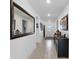 Bright hallway with tiled floors, decorative mirror, and stylish console table at 1328 Pompay Dr, Davenport, FL 33896