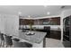 This updated kitchen features an oversized granite countertop island and modern appliances at 1328 Pompay Dr, Davenport, FL 33896
