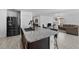 Stylish kitchen island with granite countertops, seating, and stainless steel appliances in an open layout at 1328 Pompay Dr, Davenport, FL 33896