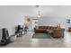 Bright and airy living room with neutral decor, large windows, and tile flooring throughout at 1328 Pompay Dr, Davenport, FL 33896