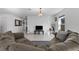 Open-concept living room with neutral tones, tiled flooring, and comfortable sectional sofa at 1328 Pompay Dr, Davenport, FL 33896