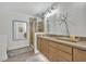 Modern bathroom with double sinks, a glass shower, and wood floors at 1342 Benevolent St, Maitland, FL 32751