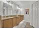Bathroom featuring double sinks, hardwood floors, and a wall mirror at 1342 Benevolent St, Maitland, FL 32751