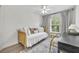 Neutral bedroom with daybed, wood floors, a ceiling fan and lots of natural light at 1342 Benevolent St, Maitland, FL 32751