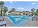Resort-style community pool with palm trees, shaded seating, and clear blue water for relaxation at 1342 Benevolent St, Maitland, FL 32751